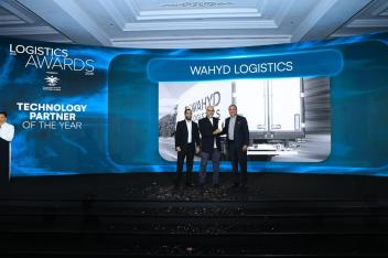 Wahyd Logistics executives on stage accepting the Technology Partner of the Year award at the Logistics Saudi Awards 2026, with the Wahyd Logistics branding displayed on the event screen behind them.
